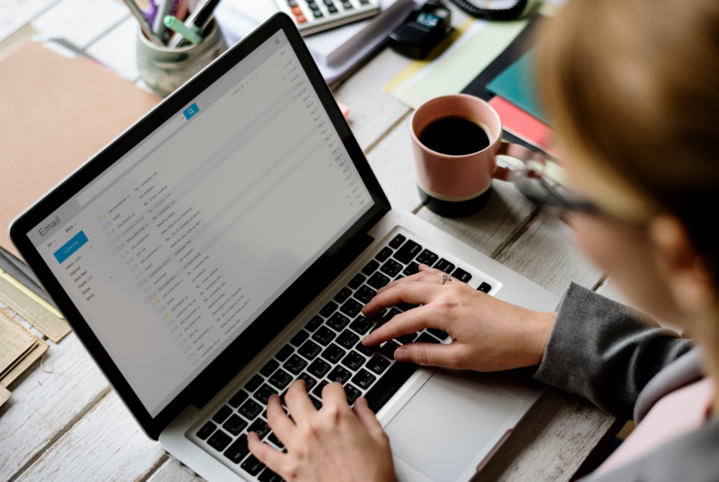 Businesswoman Checking what is double opt-in email marketing E-mail Online on Laptop